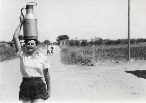 פידי (ציפורה) פליישר עם כד חלב ליד המחלבה. 1943. מארכיון המושב